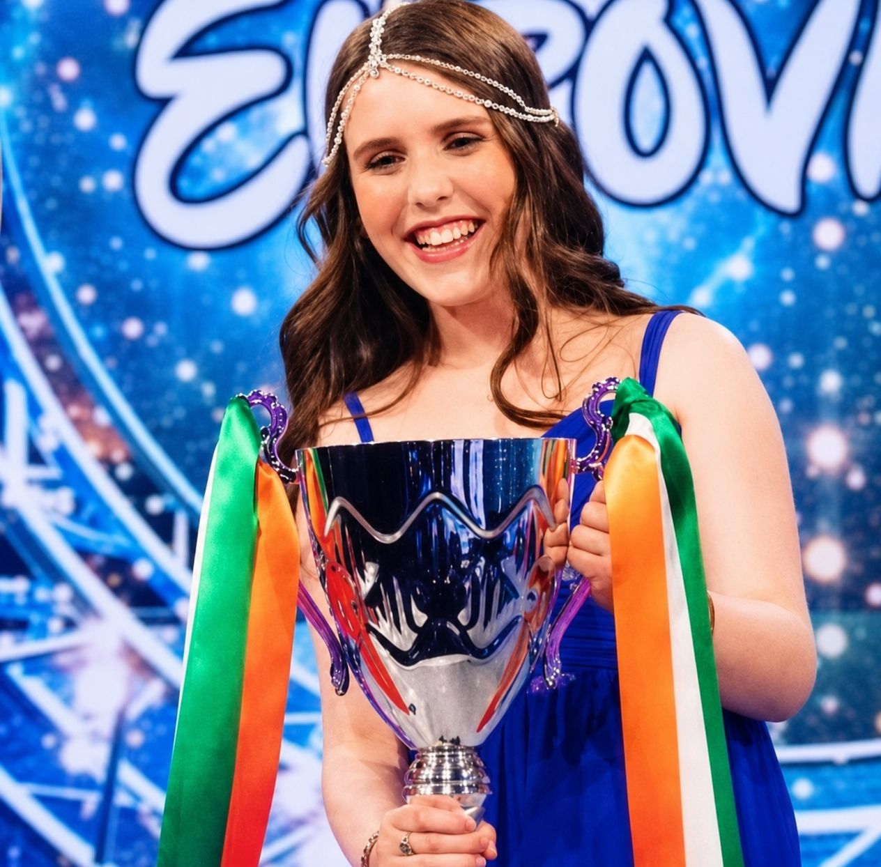 Jessica McKean holding the Junior Eurovision trophy with Irish tricolour ribbons